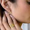 model wearing thick gold figure eight earrings