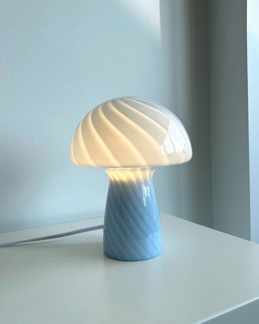 lit blue mushroom glass table lamp