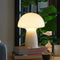 lit light yellow mushroom glass table lamp