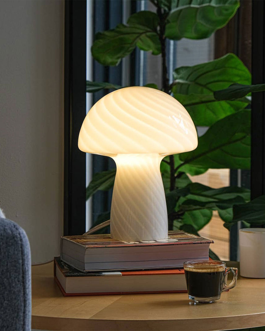 lit light yellow mushroom glass table lamp