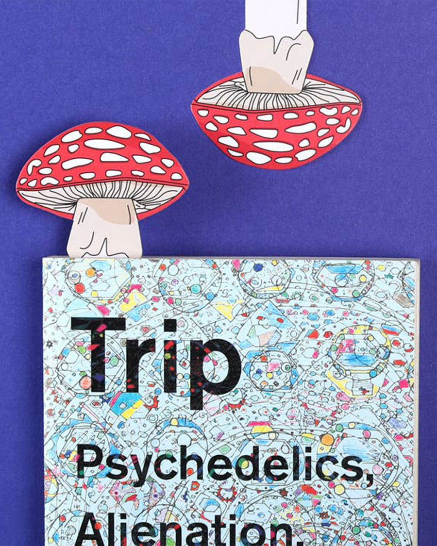red and white mushroom shaped bookmark in closed book