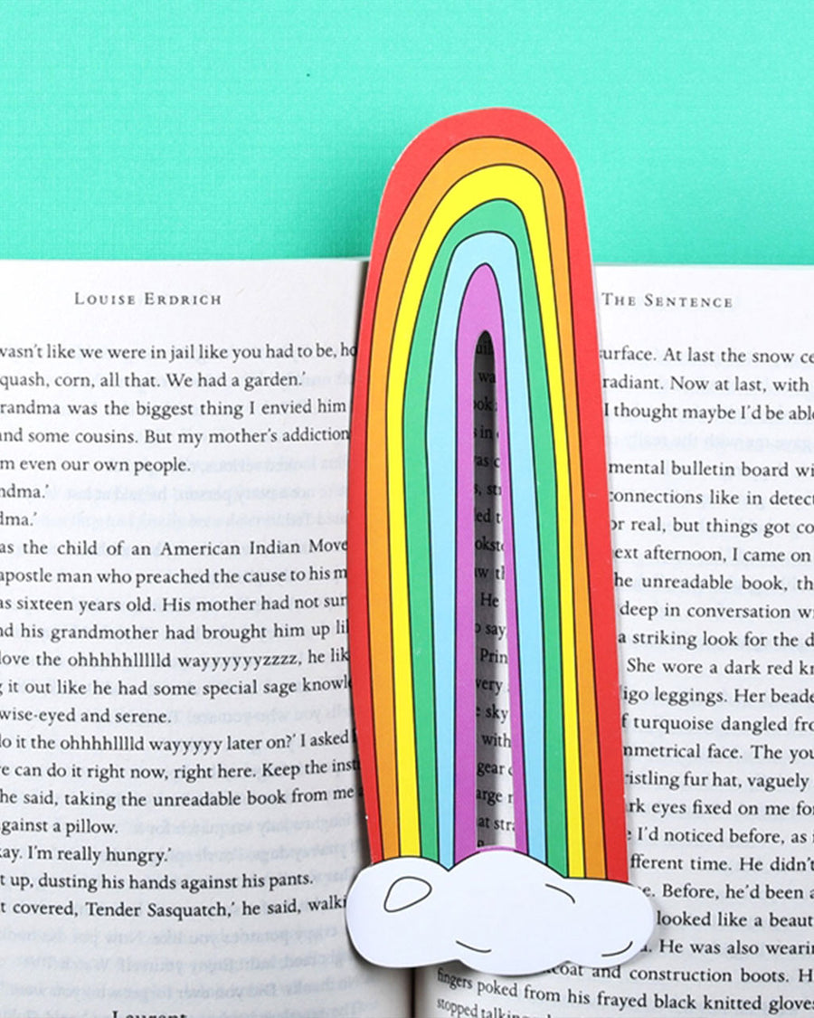 long rainbow shaped bookmark with clouds on the bottom in open book