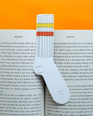 yellow and orange stripe tube sock shaped bookmark in open book