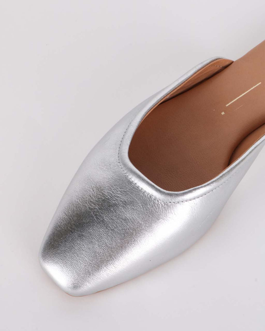 up close of metallic silver slip on mules