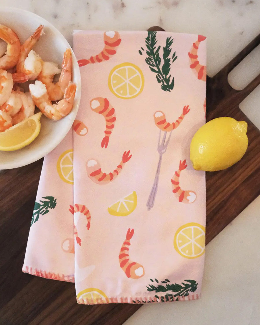light pink cotton tea towel with shrimp cocktail and lemon print