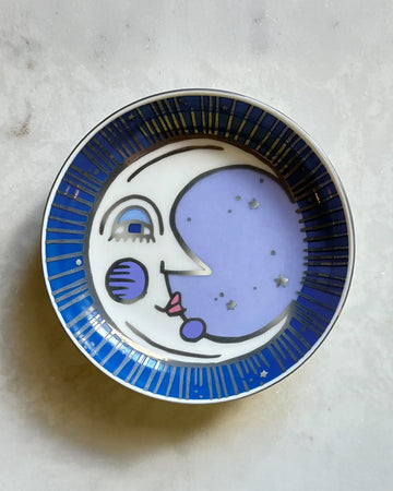 blue trinket tray with moon face print and silver detail