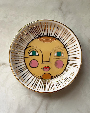 white trinket tray with sun face print and gold detail