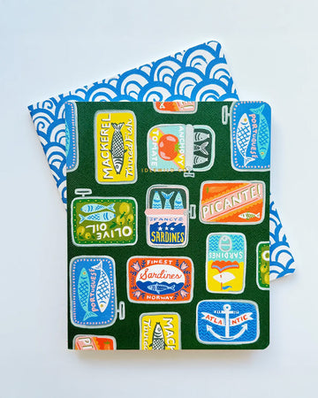 set of 2 notebooks with green with colorful tinned fish print and blue and white arch print