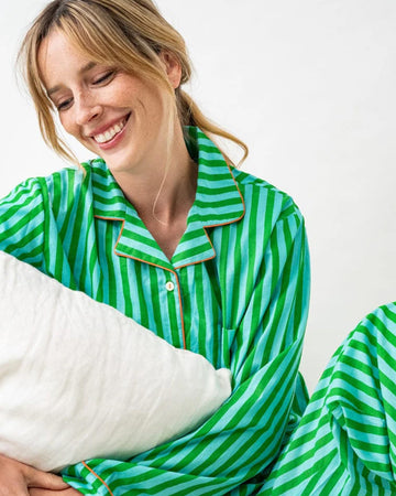 model wearing kelly green and sky blue vertical stripe pj set