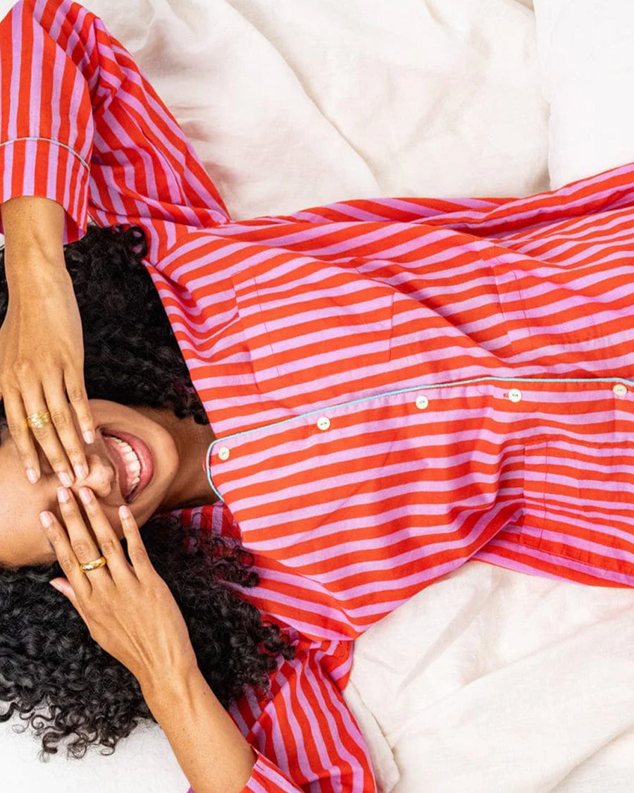 model wearing lavender and poppy vertical stripe pj set