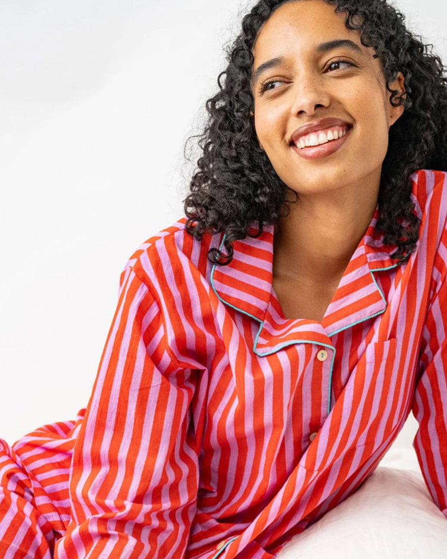 model wearing lavender and poppy vertical stripe pj set