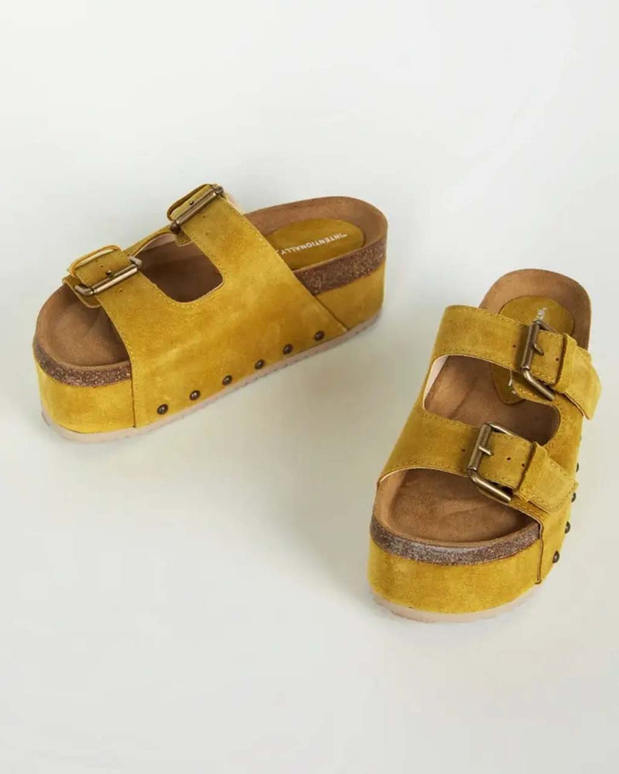 marigold platform shoes with two buckle straps and grommet details on the sides
