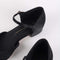 up close of black mary jane shoe with small heel and strap