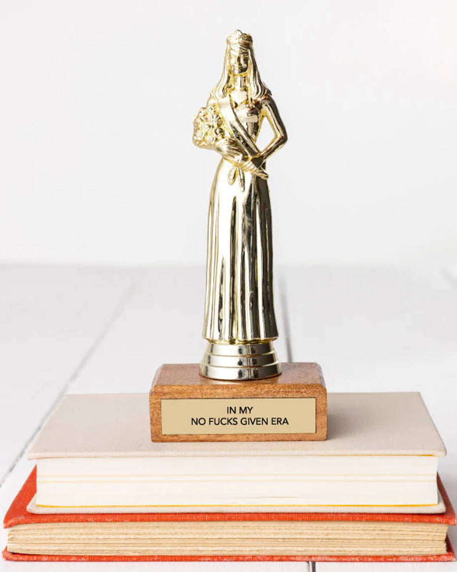 'in my no f's given era' trophy on a stack of books