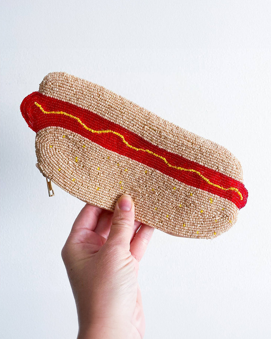 model holding hot dog shaped beaded pencil pouch