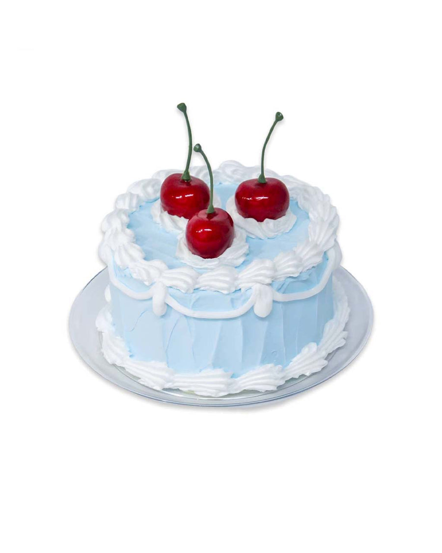 blue fake cake kit with red cherries on top
