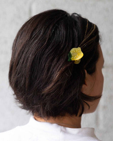 model wearing mini lemon shaped hair clip