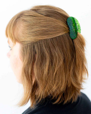 model wearing mini pickle shaped hair claw