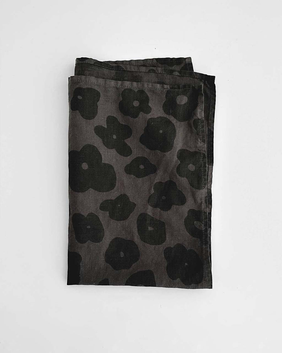 faded black tea towel with black floral print