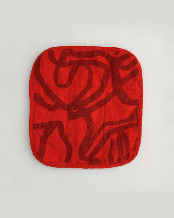 red potholder with dark red squiggle print