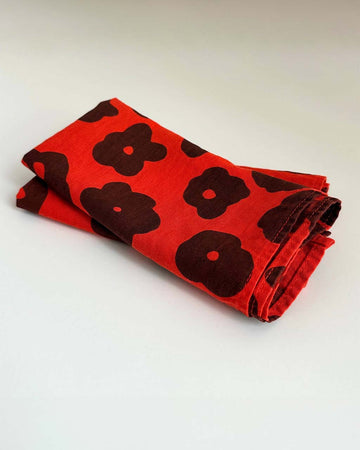 set of two red cloth napkins with black abstract flowers