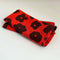 set of two red cloth napkins with black abstract flowers