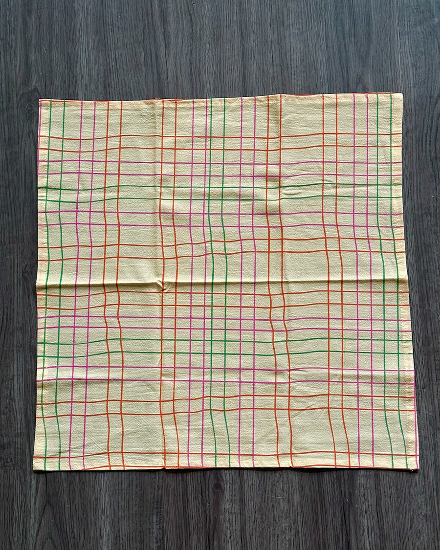 cream tea towel with colorful thin plaid print