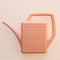 peach watering can with engraved geo design