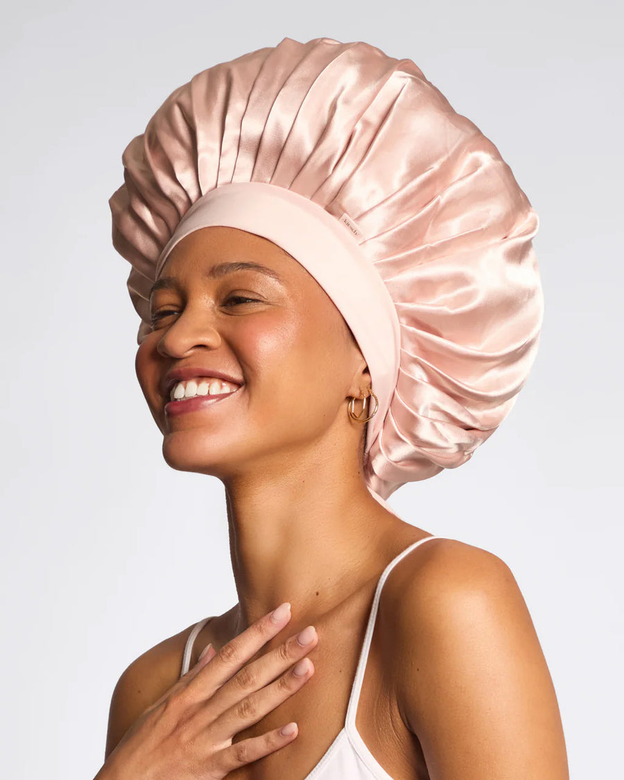 model wearing pink satin oversized satin bonnet 