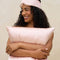 model with pink satin contour pillow eye mask on her forehead