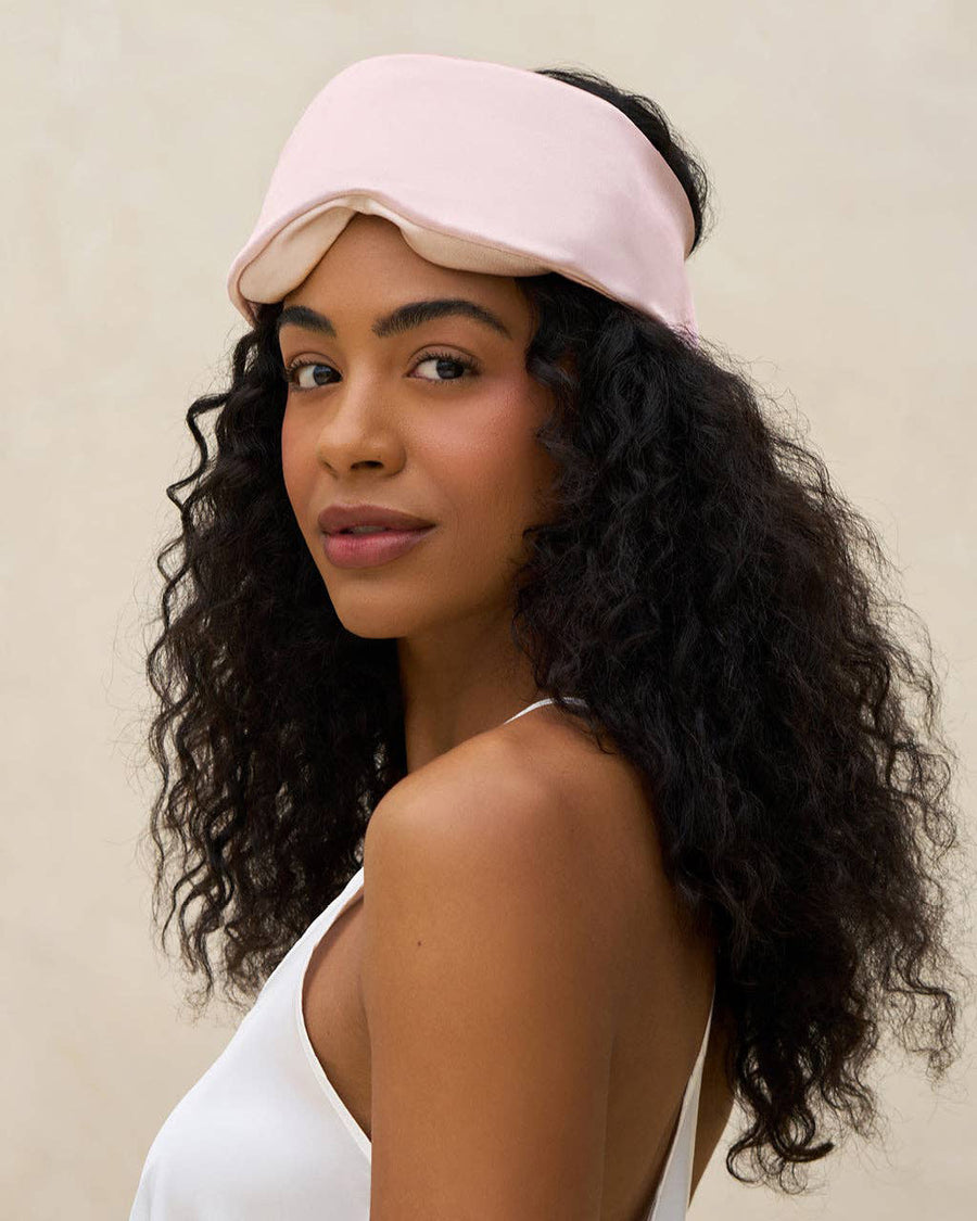 model with pink satin contour pillow eye mask on their forehead