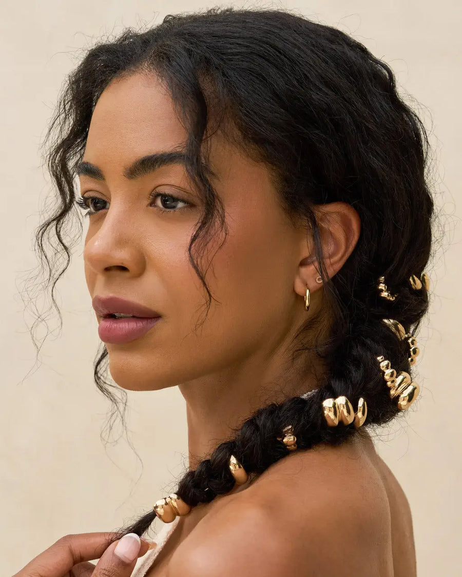 gold metal pony tail pins in models hair