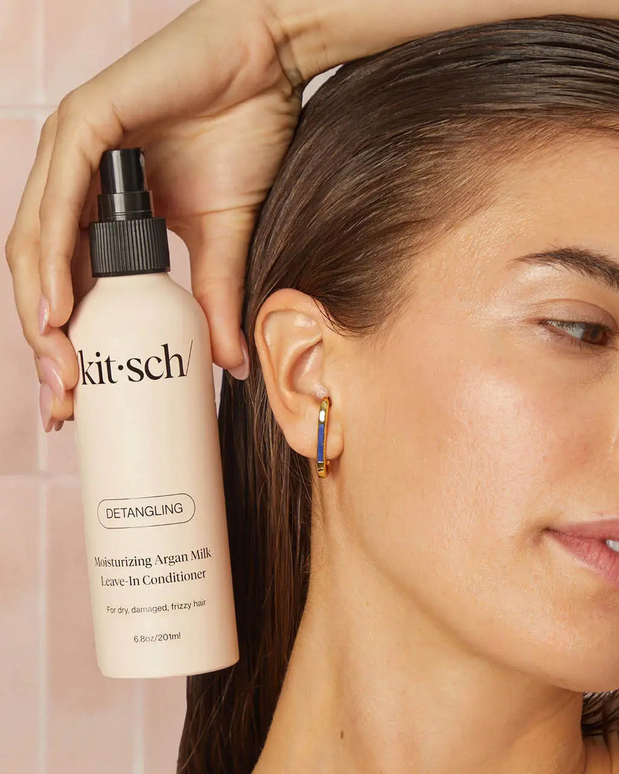 model holding Moisturizing Argan Milk Leave-in Conditioner