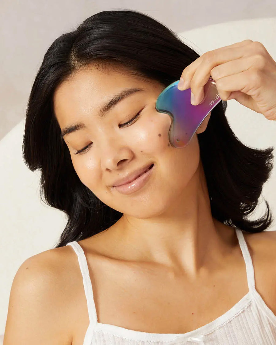 model using Iridescent stainless steel gua sha