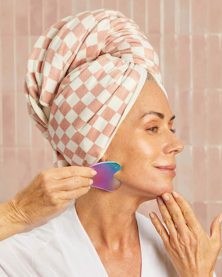 model using Iridescent stainless steel gua sha