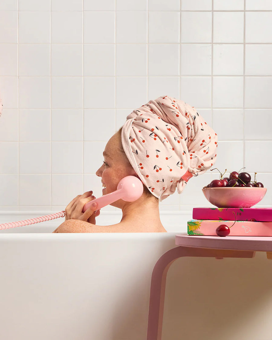 light pink large absorbent XL hair towel with all over cherry print in bathtub