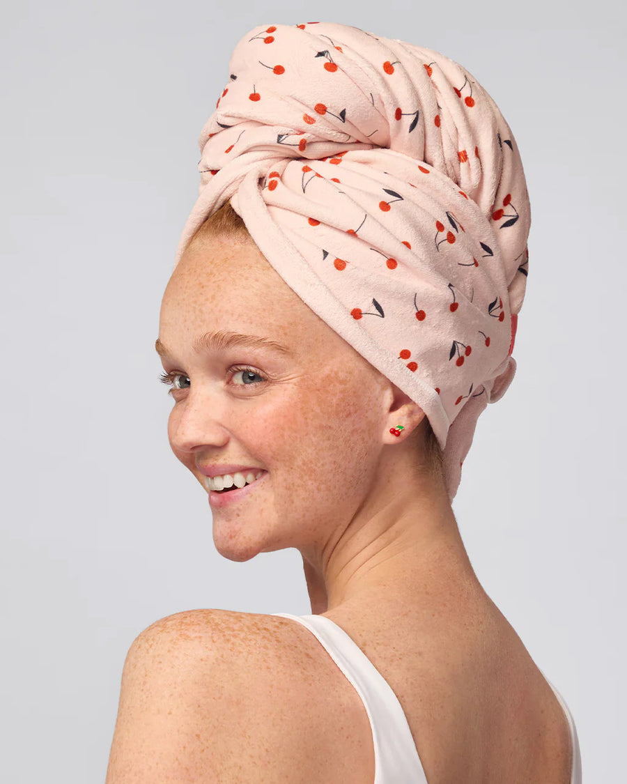 model wearing light pink large absorbent XL hair towel with all over cherry print