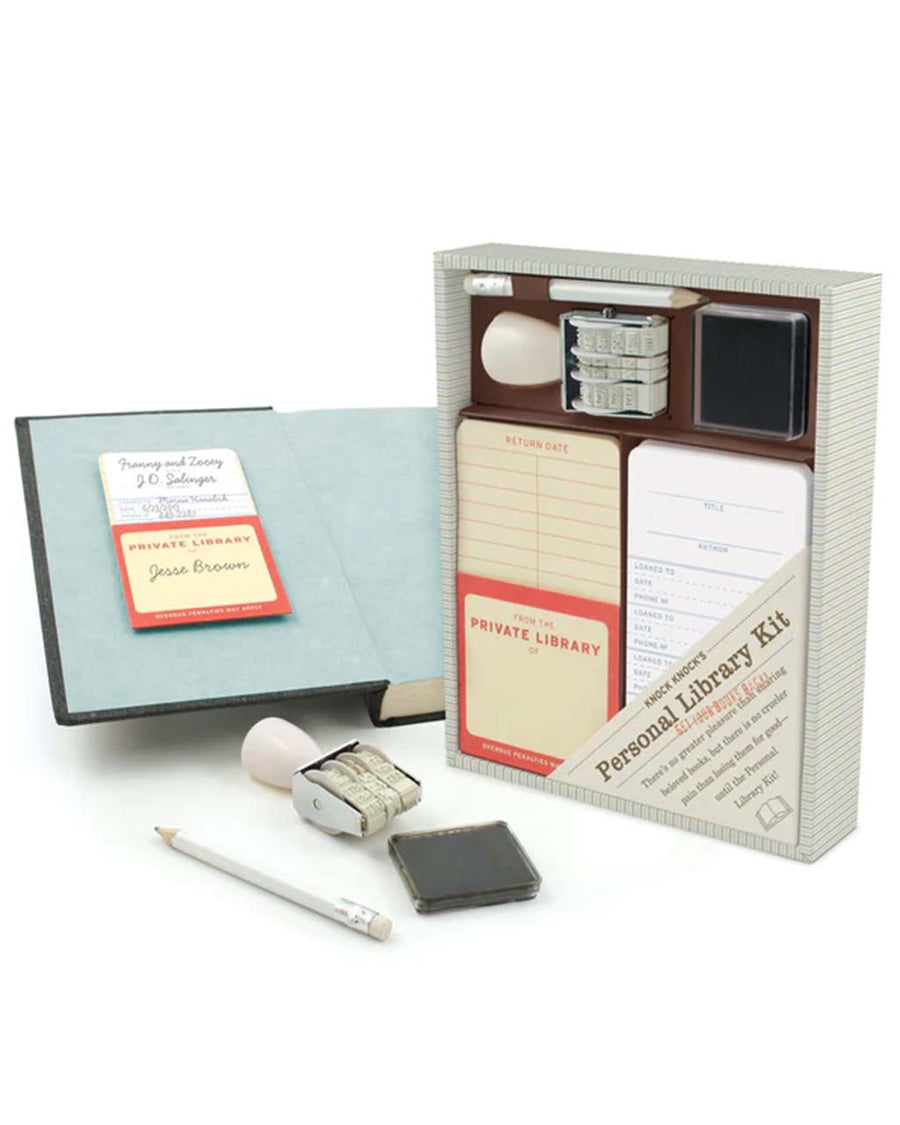 packaged personal library kit: 20 self-adhesive pockets and checkout cards, date stamp and inkpad, pencil tested on a book