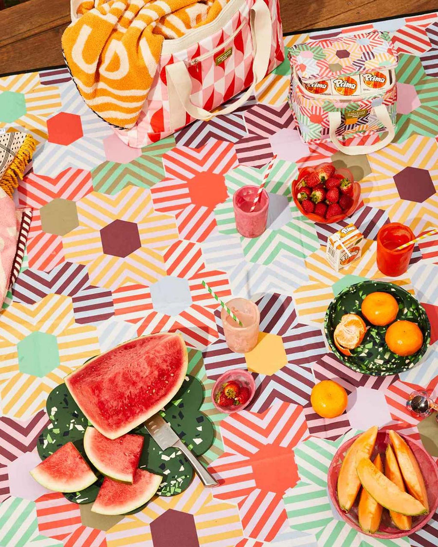 medium foldable picnic mat with colorful patchwork print with picnic items in it