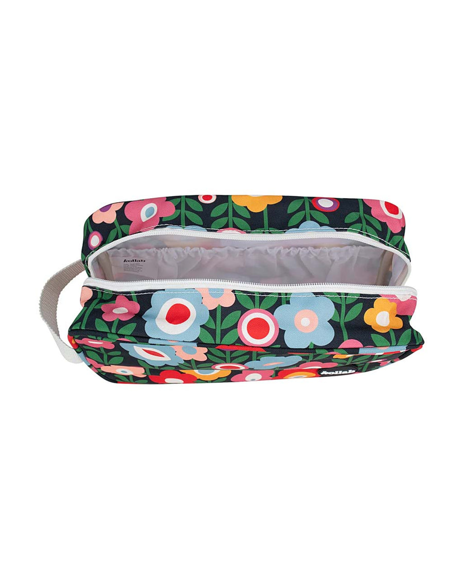 white interior of black travel bag with colorful mod floral print