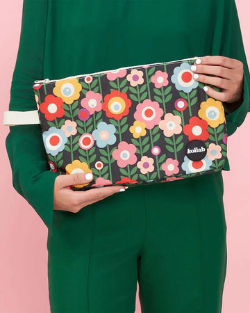 model holding black medium wet bag with colorful mod floral print