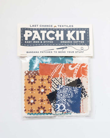 packaged patch kit with various fabric pieces and colorful embroidery thread