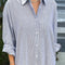 up close of model wearing relaxed fit blue and white vertical stripe shin length shirtdress