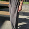 side view of model wearing cotton dark slate balloon pants with side pockets