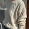 sideview of model wearing naturel cable knit crew neck sweater
