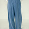 back view of model wearing cornflower cotton wide leg pants with side inlets
