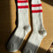 white crew socks with two red stripes on the top