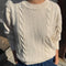 front view of model wearing naturel cable knit crew neck sweater