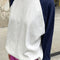 model wearing white relaxed fit raglan tee with navy sleeves