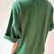 back view of model wearing moss green oversized tee with extended sleeves
